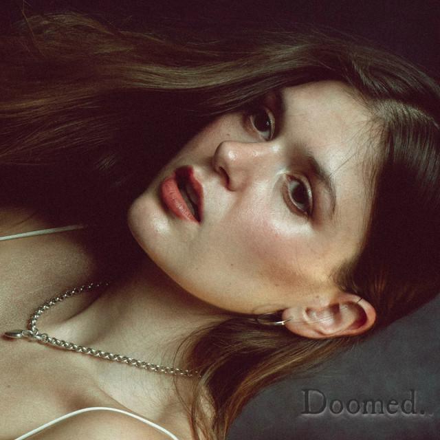 Doomed single cover — close chiaroscuro portrait of Delilah Brao